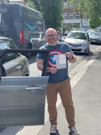 A Go Green Driving School student celebrating passing their driving test in West London