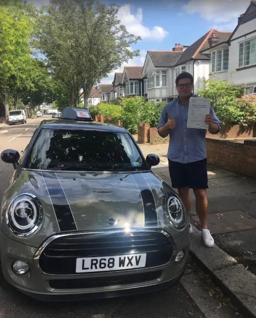 A Go Green Driving School learner celebrating their driving test pass
