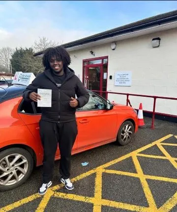 A Go Green Driving School learner celebrating their driving test pass